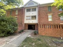 Brick building exterior features balconies and covered parking at 3522 Ivy Commons Dr # 101, Raleigh, NC 27606