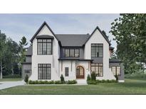 Striking two-story home showcasing a modern aesthetic with its brick facade and sleek black-trimmed windows at 5013 Coronado, Raleigh, NC 27609