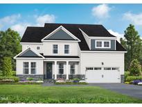 Charming two-story home with a two-car garage, landscaped yard, and inviting front porch at 5060 Trotter Dr, Raleigh, NC 27603