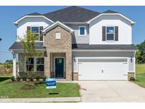 Charming two-story home with a brick facade, two-car garage, and well-manicured lawn at 667 White Birch Ln, Angier, NC 27501