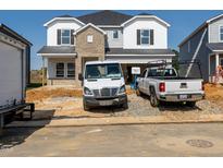 Exterior view of home under construction with a brick facade and white siding details at 667 White Birch Ln, Angier, NC 27501