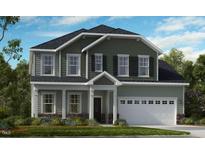 Charming two-story home with a well-manicured lawn and a two-car garage at 673 Sun Meadow Dr, Wake Forest, NC 27587