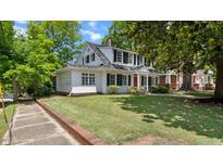 Charming two-story home with black shutters and a well-maintained front lawn at 830 S Chestnut St, Henderson, NC 27536