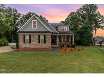 Charming brick home with manicured lawn, inviting curb appeal and craftsman details at 90 Starwood Dr, Garner, NC 27529