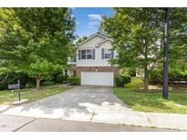 Charming two-story home with well-manicured lawn and inviting curb appeal at 925 Spring Meadow Dr, Durham, NC 27713