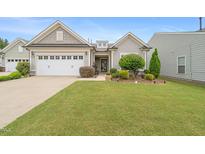 Charming single-Gathering home with a well-manicured lawn, attractive landscaping, and a two-car garage at 104 Spindle Dr, Durham, NC 27703