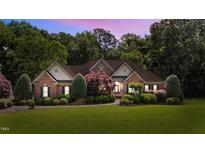 Beautiful brick home with mature landscaping and a welcoming entrance for curb appeal at 12504 Bayleaf Church Rd, Raleigh, NC 27614