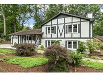 Charming two-story home with a beautifully landscaped front yard, featuring Tudor-style architecture at 1420 Seabrook Ave, Cary, NC 27511