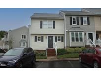 Charming townhome featuring classic siding, well-kept landscaping, and a welcoming entrance at 1910 Trexler Ct, Raleigh, NC 27606