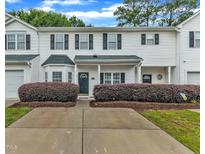 Charming townhome with a well-manicured front yard and a covered entrance, blending comfort and curb appeal at 220 Misty Groves Cir, Morrisville, NC 27560