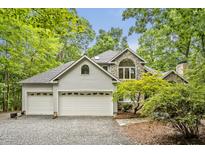 Charming two-story home featuring a stone facade, three-car garage, and lush landscaping at 2606 Sherbrooke Dr, Durham, NC 27712