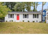 Charming single-story home with a red front door and well-maintained lawn at 2612 Glenbrook Dr, Durham, NC 27704
