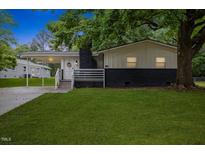 Charming home featuring a covered entrance, dark brick accents and a well maintained lawn at 2752 Weldon Ter, Durham, NC 27703