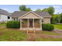 Charming bungalow with a welcoming front porch and beautiful landscaping at 325 Martin Luther King Jr Blvd, Raleigh, NC 27601