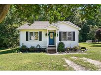 Charming single-story home with blue door and manicured front lawn and classic siding at 364 Chinaberry Ln, Angier, NC 27501