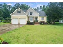Charming two-story home with a well-manicured lawn and attached two-car garage in a lush green neighborhood at 3916 Rustic Mill Dr, Apex, NC 27539