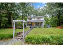 Charming two-story home with inviting front porch and stone pathway through the landscaped front yard at 4777 Helena Moriah Rd, Rougemont, NC 27572