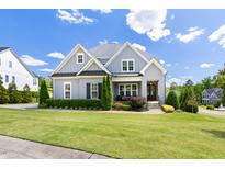 Charming two-story home with a well-manicured lawn, beautiful landscaping, and a welcoming front porch at 5100 Schellinger, Raleigh, NC 27612