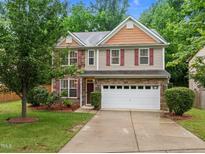 Charming two-story home with a stone accent, a two-car garage, and a well-manicured lawn at 552 Stobhill Ln, Holly Springs, NC 27540