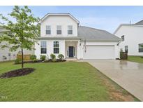 Charming two-story home with a well-manicured lawn and inviting front porch at 60 Silent Brook Trl, Franklinton, NC 27525