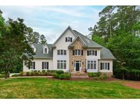 Beautiful two-story home with manicured lawn, stone accents, and many windows at 636 Pendleton Lake Rd, Raleigh, NC 27614