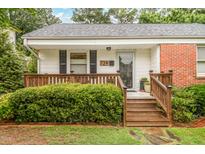 Charming one-story home with a inviting front porch, manicured lawn, and lush landscaping at 729 Mial St, Raleigh, NC 27608