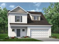 Charming two-story home featuring a symmetrical facade, attached garage, and well-manicured lawn at 73 Pine Vista Way, Sanford, NC 27332