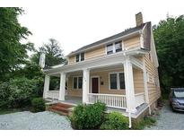 Charming two-story home featuring a welcoming front porch with classic white columns at 803 W Club Blvd, Durham, NC 27701