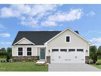 Charming single-Gathering home featuring a two-car garage, stone accents, and a well-manicured lawn at 84 Saintsbury Dr, Fuquay Varina, NC 27526