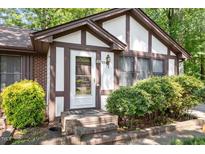 Charming home featuring a tidy front entrance with brick steps and well-maintained landscaping at 103 Castill Pl, Garner, NC 27529