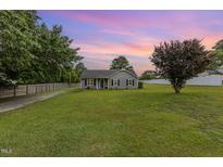 Charming single-story home with gray siding, complemented by a spacious front yard and inviting curb appeal at 109 D A King Dr, Willow Springs, NC 27592