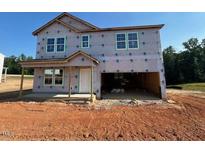 Unfinished two-story home with an attached two-car garage and a covered front porch at 135 Cordoba Dr, Franklinton, NC 27525