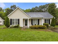 Charming single-story home with light siding, black shutters, and a well-maintained lawn at 139 Carriage Hill Dr, Stem, NC 27581