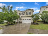 Charming two-story home featuring a well-manicured lawn, an attached garage, and lovely curb appeal at 1920 Bright Kannon Way, Wendell, NC 27591