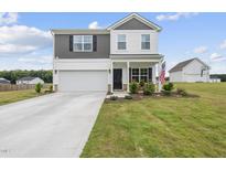 Charming two-story home with a manicured lawn, attached garage and welcoming front porch at 200 Gill Farm Way, Franklinton, NC 27525
