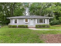 Charming single story home featuring gray siding, white trim, and manicured landscaping at 2015 Walnut St, Durham, NC 27705