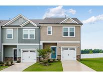 Charming townhome featuring a one-car garage, well-manicured lawn, and inviting curb appeal at 269 Hank Way, Angier, NC 27501