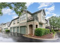 Charming townhouse with stone accents, green trim, and a private balcony, offers a sophisticated curb appeal at 301 Presque Isle Ln, Chapel Hill, NC 27514