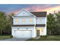 Charming two-story home featuring a welcoming facade and a well-manicured front lawn at 3214 Pelican Ln, Durham, NC 27703