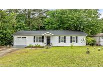 Charming one-story home features black shutters and a well-manicured lawn at 3803 Jonesville Rd, Wake Forest, NC 27587