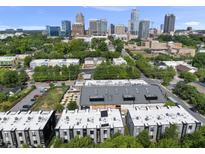 Stunning aerial view of modern townhomes in the city with a rooftop and lush greenery at 414 Chavis Way, Raleigh, NC 27601