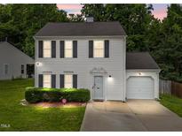 Charming two-story home featuring a well-manicured lawn, attached garage, and white siding at 4221 Ivy Hill Rd, Raleigh, NC 27616