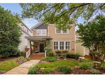 Charming two-story home featuring a welcoming front porch and beautifully landscaped front yard at 4409 All Points View Way, Raleigh, NC 27614