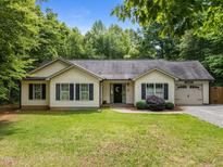 Charming ranch-style home with green lawn, dark shutters, one-car garage, and mature landscaping at 4508 Alice Dr, Oxford, NC 27565
