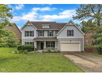 Charming two-story home featuring traditional architectural details and a well-manicured lawn at 5025 Stonewood Pines Dr, Knightdale, NC 27545