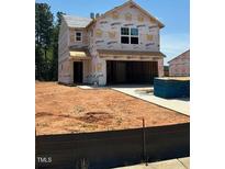 Unfinished exterior view of a two-story home with a large garage and visible framework at 51 Crow Field St, Roxboro, NC 27574