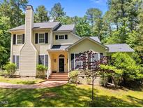 Charming two-story home with classic architectural features and beautifully landscaped front yard in a lush neighborhood at 676 Whitehurst, Pittsboro, NC 27312