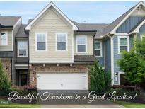 Charming townhome with stone accents, neutral siding, and a well-manicured front yard at 707 Newlyn Dr, Raleigh, NC 27606