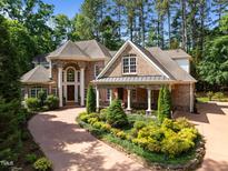 Stunning brick home featuring manicured landscaping, stone accents, and a grand entrance at 71012 Russell, Chapel Hill, NC 27517