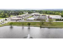 Aerial view of the community with a lake and a shopping center nearby at 72 S Grey Abbey Dr, Clayton, NC 27527